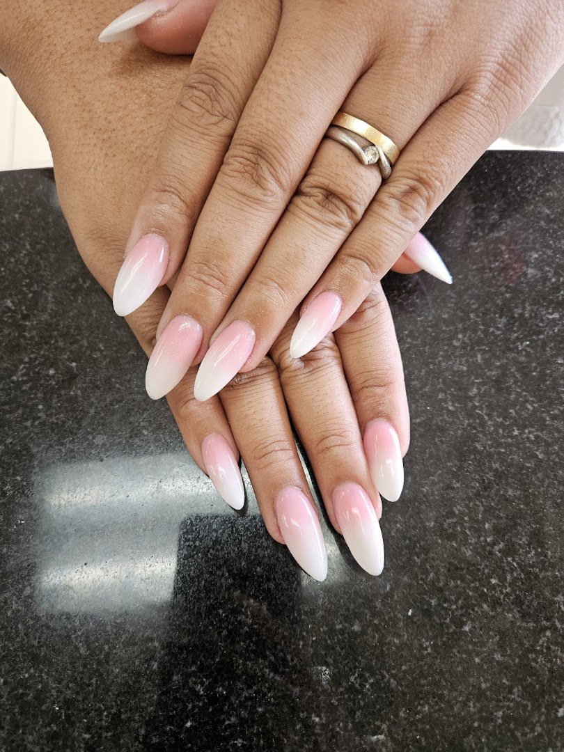 Manicured nails under soft salon lighting.