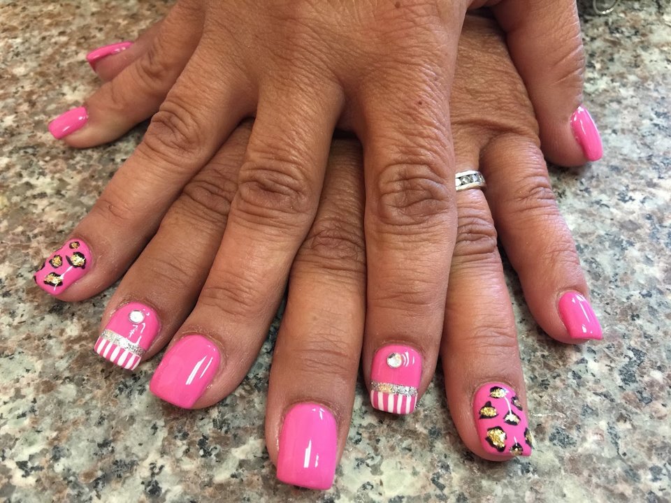 Nail technician shaping a fresh manicure.